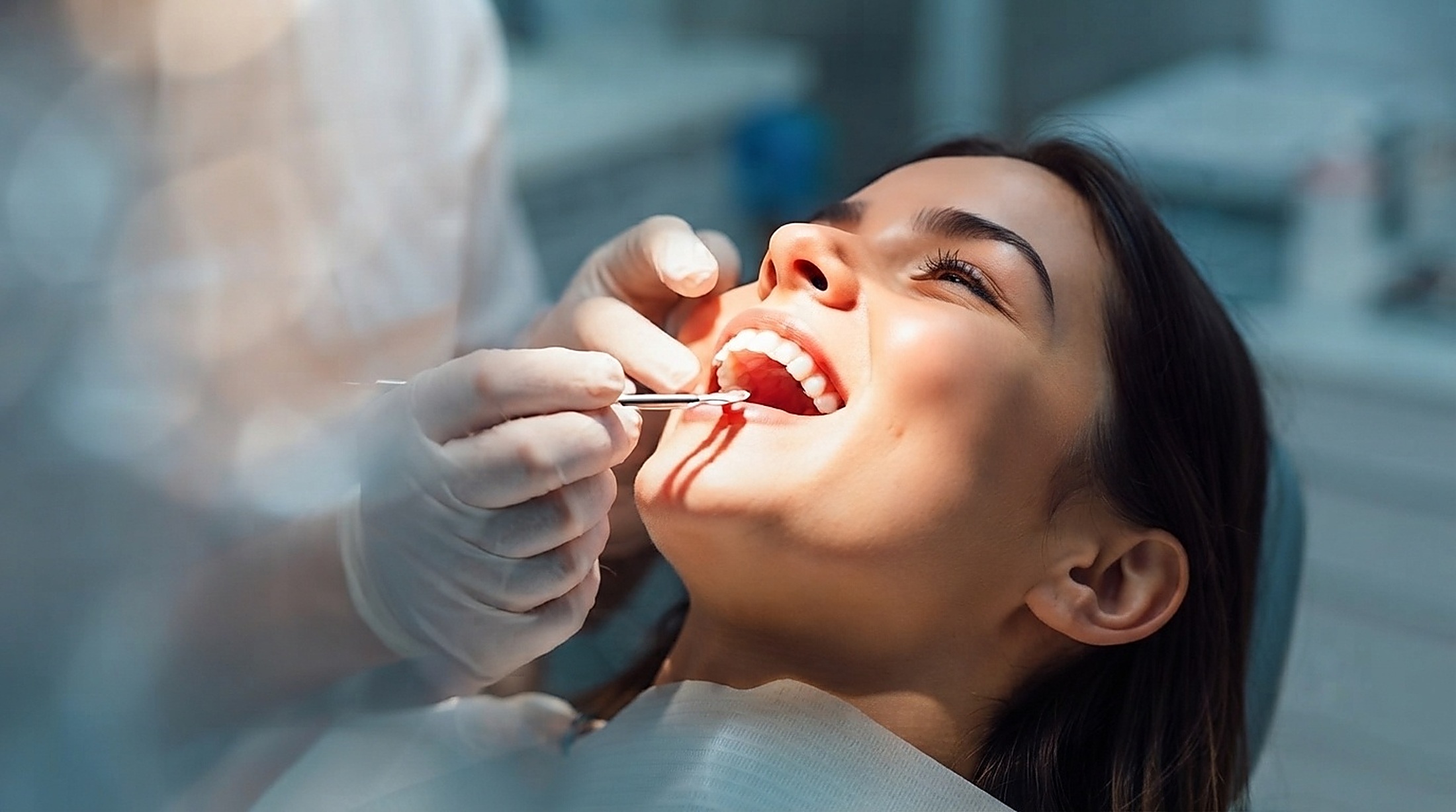 Dentist examining a smiling patient at White Teeth Dental